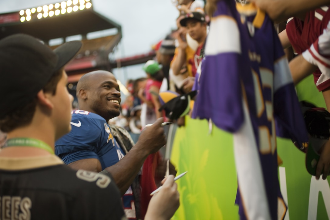 Minnesota Vikings running back Adrian Peterson signs autographs for waiting fans after the 2013 NFL Pro Bowl at Aloha Stadium, Jan. 27. Peterson nearly broke the single-season NFL rushing record this year, falling only nine yards shy. Peterson stayed long after the game to sign autographs. 
