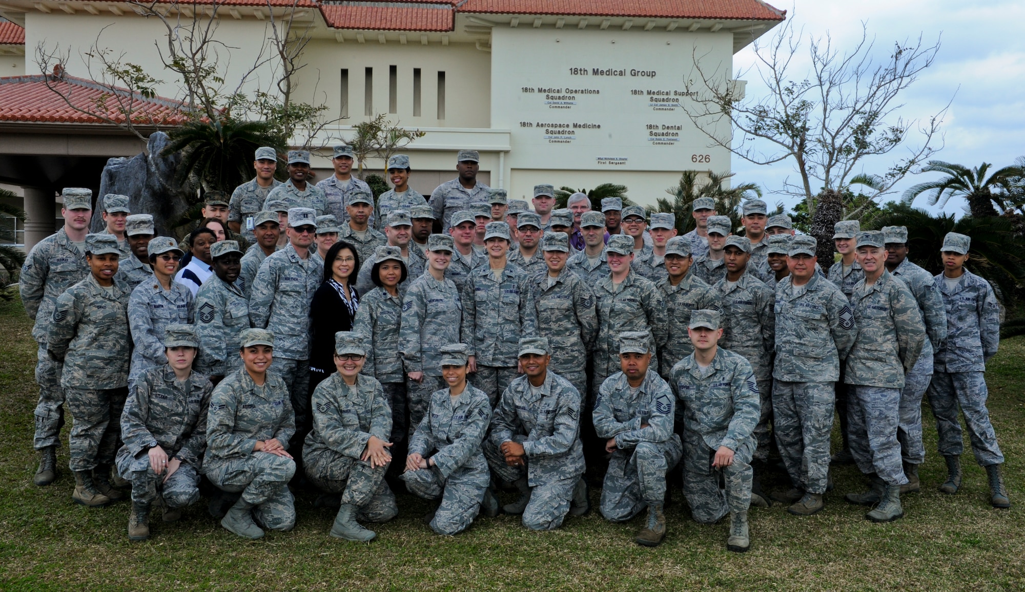 18th Medical Group personnel get together for a group photo at the 18th Medical Group building on Kadena Air Base, Japan, Jan. 24, 2013. The 18th MDG is the Air Force's largest freestanding ambulatory clinic in terms of personnel and it holds more than 80 medical and dental care providers. (U.S. Air Force photo/Airman 1st Class Justin Veazie)
