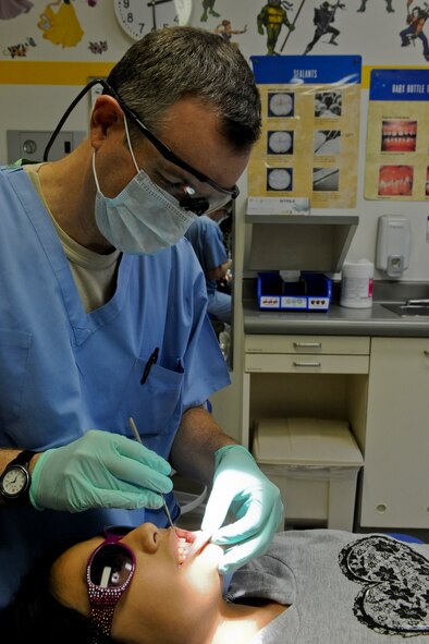 U.S. Air Force Lt. Col. Gray Hicks, 18th Medical Group pediatric dentist, performs an annual checkup on Kadena Air Base, Japan, Jan. 24, 2013. The 18th Dental Squadron provides general dentistry as well as specialty care in orthodontics, pediatric dentistry, periodontics, prosthodontics, endodontics and oral surgery. The dental clinic won the Pacific Air Forces' Largest Dental Clinic of the Year for 2012. (U.S. Air Force photo/Airman 1st Class Justin Veazie)