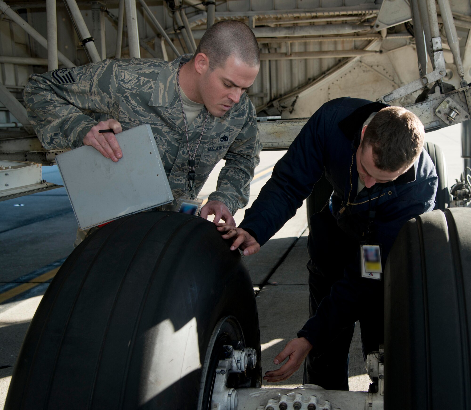 Tech. Sgt. Brandon St. Peter, 60th Maintenance Group Quality Assurance inspector, inspects Senior Airman Mark McGovern, 60th Aircraft Maintenance Squadron crew chief, on a gear inspection of a C-5 Galaxy  at Travis Air Force Base, Calif., Jan. 30, 2013. McGovern checks the serviceability of the brakes, that there are two ware pin indicators per wheel and that they are serviceable and that the piston caps have safety wire. The QA team has increased the number of inspections performed on maintainers to help them feel more comfortable with the inspection process. The LCAP starts Sunday and run through Feb. 10, 2013.(U.S. Air Force photo/Airman 1st Class Nicole Leidholm)