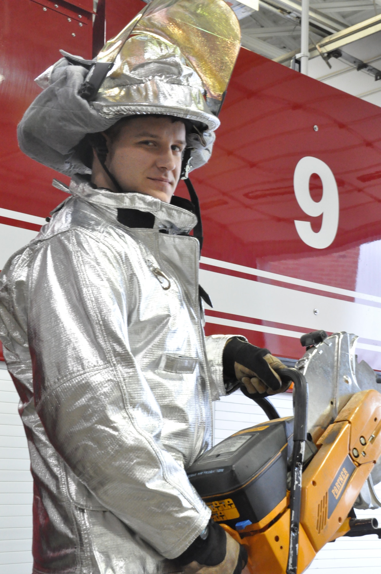 Staff Sgt. James Fligor, 375th Civil Engineer Squadron fire department crew chief rescued an unconscious maintainer inside the belly of the aircraft during his deployment to Al-Dhafra Air Base. To reach the victim in the planes fuel cell, the firefighters removed their protective gear except for their breathing apparatuses and crawl through passages. (U.S. Air Force photo/Airman 1st Class Jake Eckhardt)