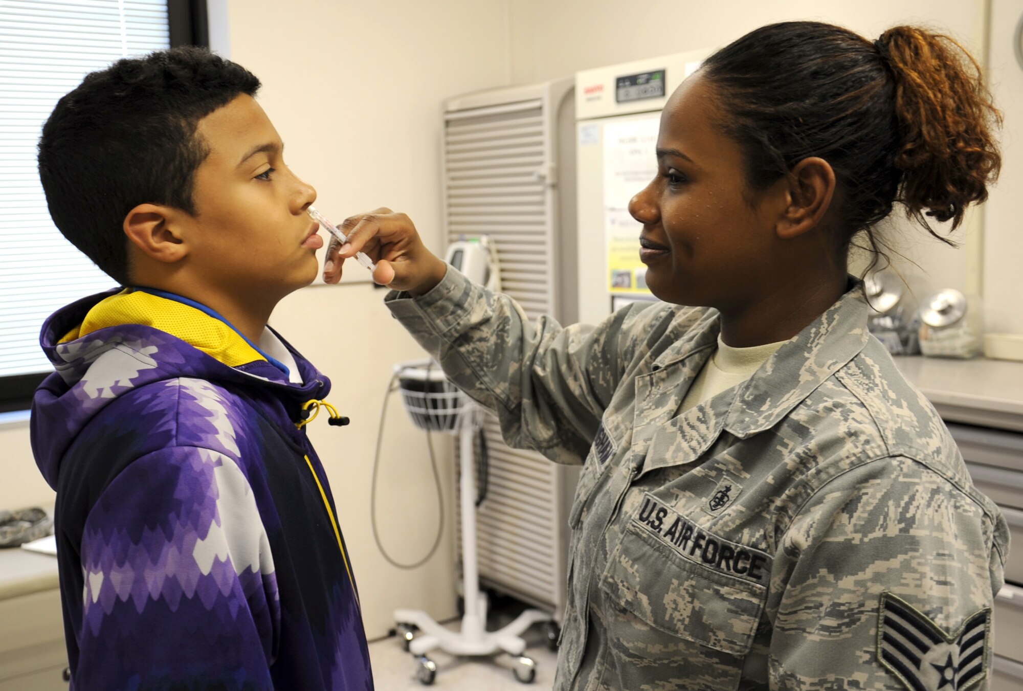 Staff Sgt. Lucretia Cunningham, 375 Medical Group allergy and immunization technician, administers the flu vaccination at the clinic Jan. 24.  Vaccines are available in the Scott Immunizations Clinic on the first floor of the medical clinic.  Normal duty hours are Monday through Friday from 7:30 a.m. to 4 p.m. on a walk-in basis.  (U.S. Air Force photo/Staff Sgt. Maria Bowman)