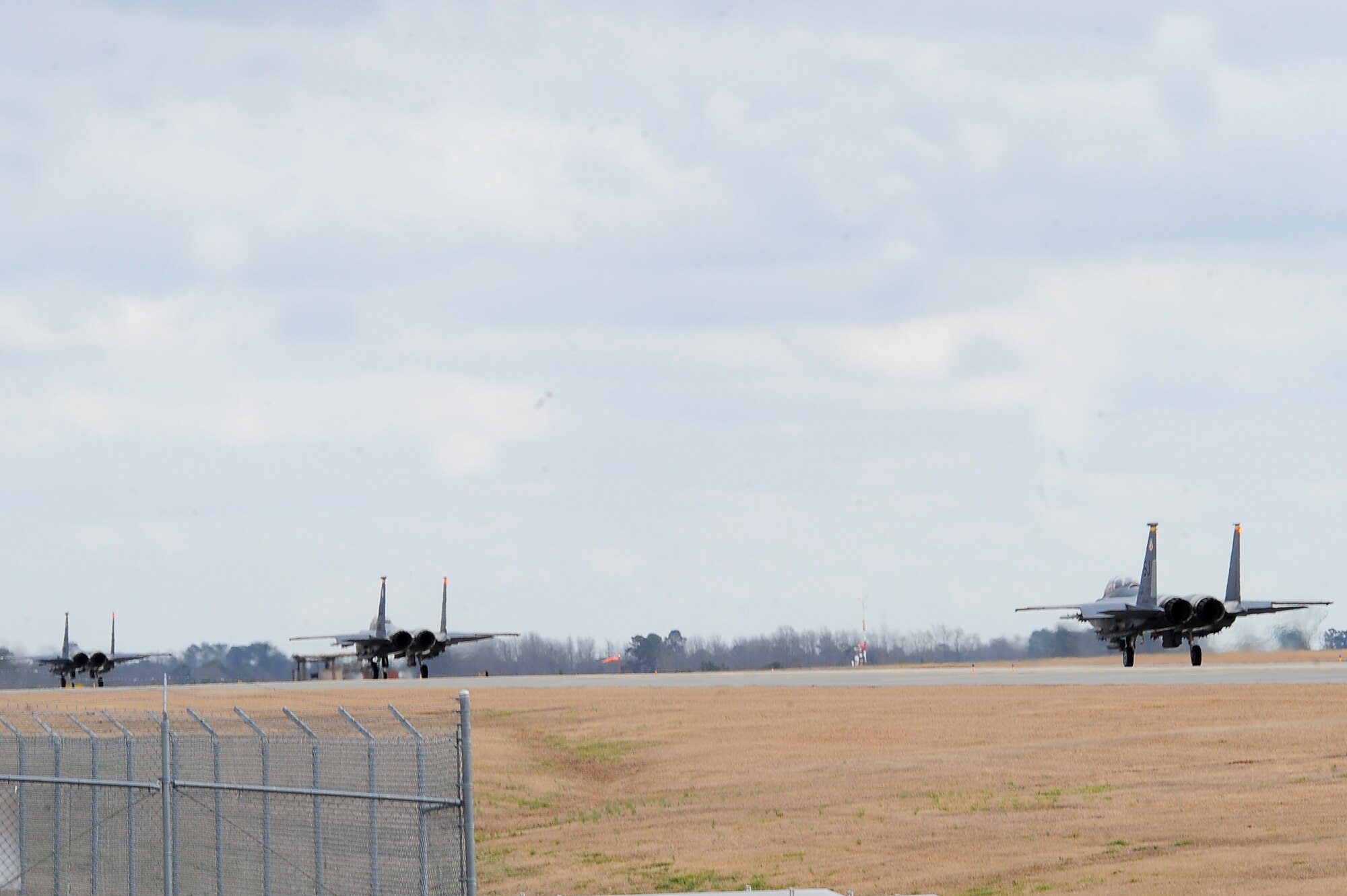 F-15E Strike Eagles taxi on the flight line prior to take off during Operational Readiness Exercise Coronet Warrior 13-01B, at a simulated deployed location on Seymour Johnson Air Force Base, N.C., Jan. 30, 2013. Airmen demonstrated their ability to employ and sustain forces during simulated attacks and fluctuating force protection conditions. (U.S. Air Force photo/Airman 1st Class Aubrey White/Released)