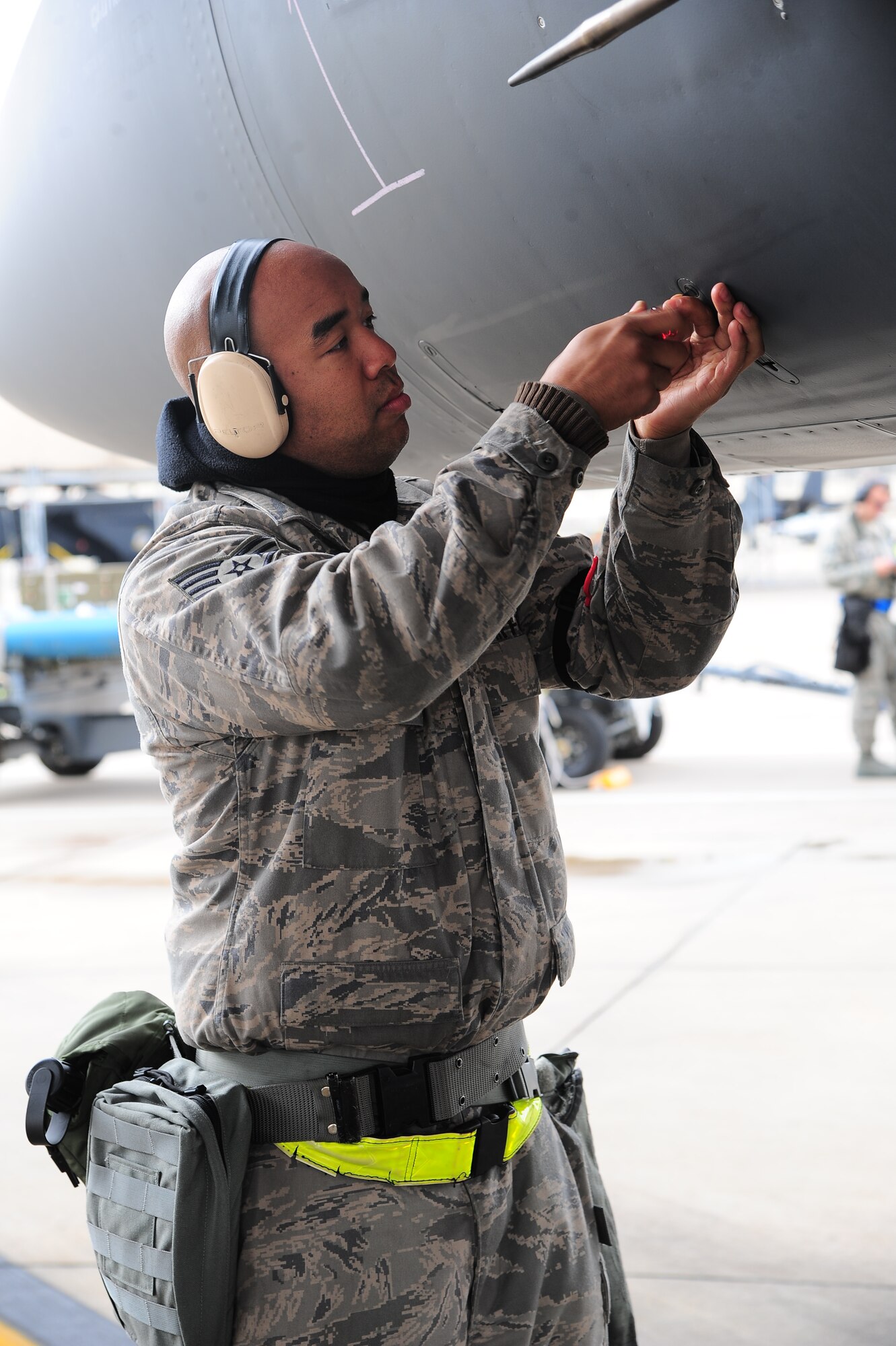 U.S. Air Force Staff Sgt. Sydney Chapman, 4th Aircraft Maintenance Squadron crew chief, secures a panel on an F-15E Strike Eagle during Operational Readiness Exercise Coronet Warrior 13-01B, at a simulated deployed location on Seymour Johnson Air Force Base, N.C., Jan. 30, 2013. Maintenance personnel were tested on their capability to maintain and generate aircraft for takeoff during fluctuating force protection conditions. (U.S. Air Force photo/Airman 1st Class Aubrey White/Released)