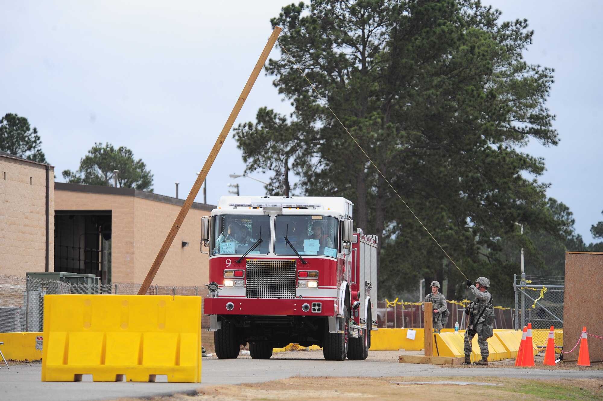 A U.S. Air Force Airman assigned to the 4th Security Forces Squadron allows a fire truck pass through an entry control point during Operational Readiness Exercise Coronet Warrior 13-01B, at a simulated deployed location on Seymour Johnson Air Force Base, N.C., Jan. 30, 2013. Security forces personnel established a single point of entry to reduce the likelihood of hostile forces entering the base. (U.S. Air Force photo/Airman 1st Class Aubrey White/Released)