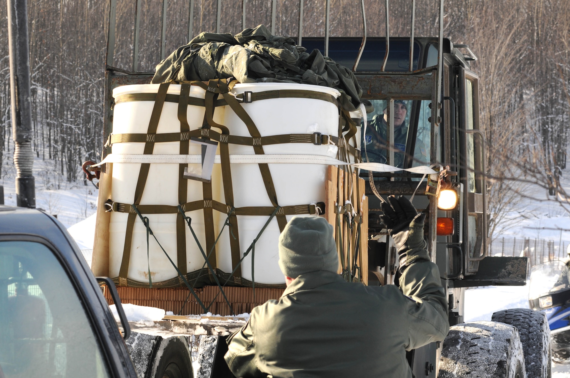 U.S. Air Force Airmen from the 110th Airlift Wing, 172nd Airlift Squadron recover a cargo drop from C-130’s, Grayling Air Gunnery Range, Frederic, Mich., Jan. 26, 2013. Cargo was dropped to certify the range and personnel in ground recovery. (U.S. Air Force photo by Tech. Sgt. David Eichaker/released)