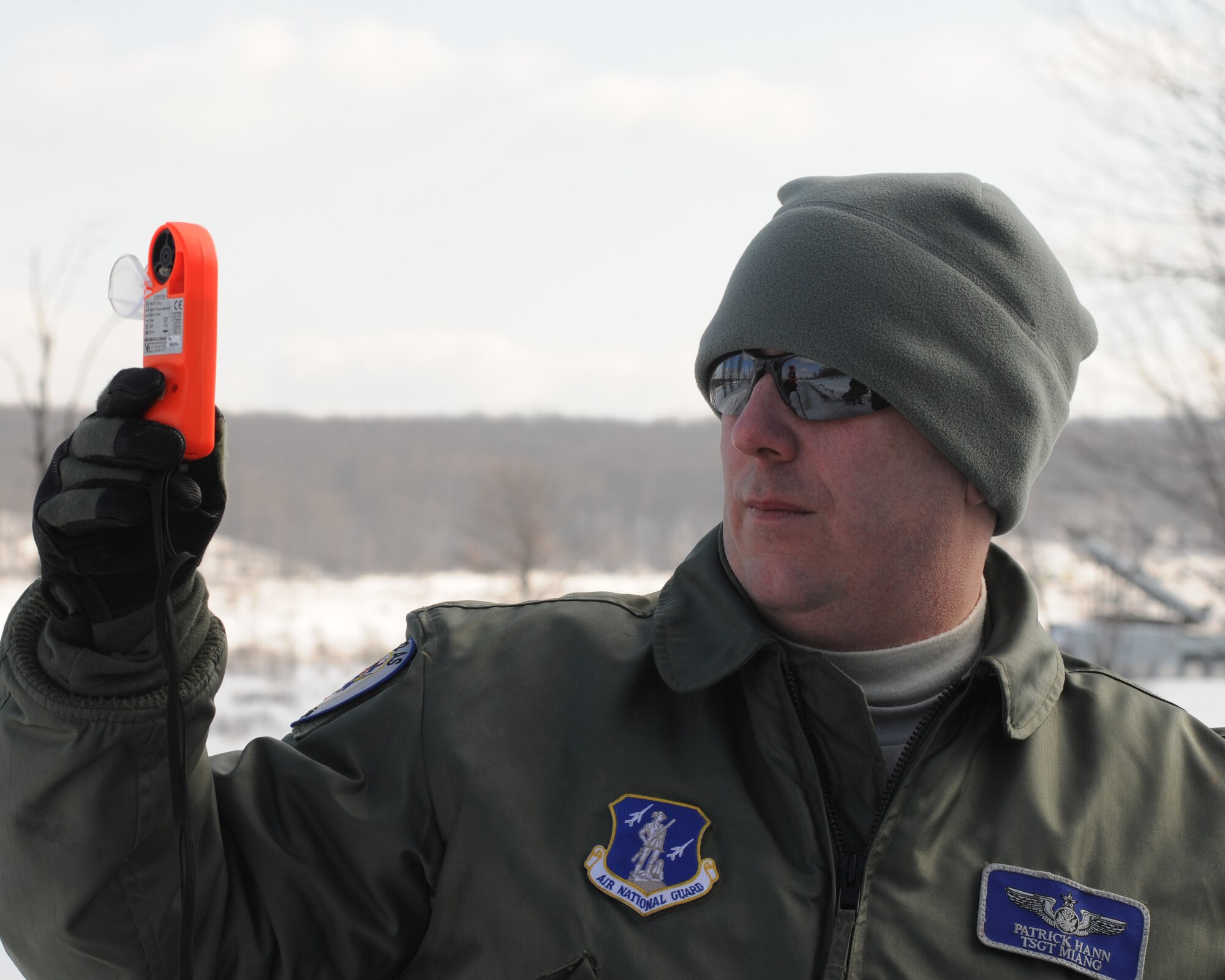U.S. Air Force Tech. Sgt. Patrick Hann, 110th Airlift Wing, 172nd Airlift Squadron obtains air temperatures and wind speeds at ground level in preparation for a cargo air drop, Grayling Air Gunnery Range, Frederic, Mich., Jan. 26, 2013.  Hann obtained this information to pass on to the pilots to obtain better accuracy of cargo placement. (U.S. Air Force photo by Tech. Sgt. David Eichaker/released)