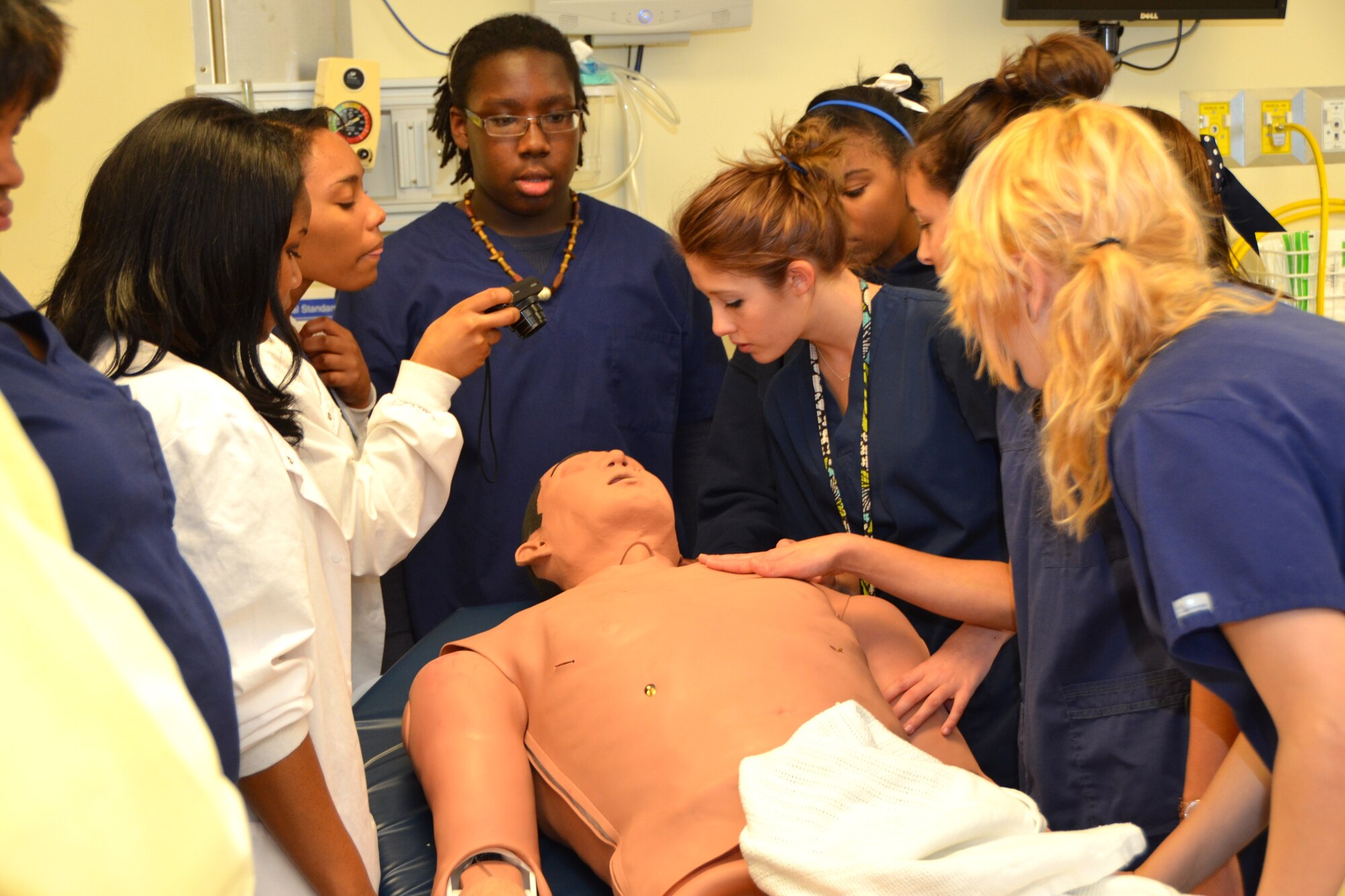 Members of the Gautier High School allied health class visiting the Keesler Hospital Jan. 25, 2013, scrutinize a lifelike training mannequin in the 81st Medical Group Patient Simulation Labat Keesler Air Force Base, Miss.  The lab was just one area the group of 40 students and chaperones had the opportunity to see during their tour.  (U.S. Air Force photo by Steve Pivnick)