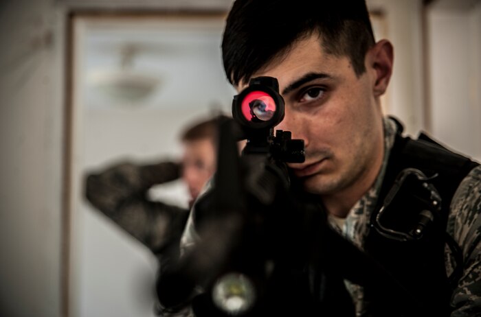 Staff Sgt. Brayden Dockendorf, 628th Security Forces Squadron patrolman, looks through the scope mounted on his M4 carbine while performing close quarters battle training Jan. 28, 2013, at Joint Base Charleston – Air Base, S.C. The unit requires all of its members to perform the CQB training twice a year. (U.S. Air Force photo/Senior Airman Dennis Sloan)