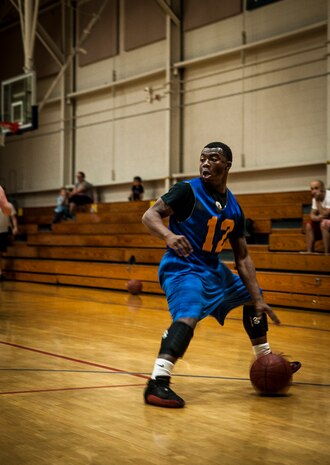 Xavier Miles, 628th Comptroller Squadron, looks for an open man during an intramural basketball  game against the 628th Logistics Readiness Squadron Jan. 29, 2013, at Joint Base Charleston, S.C. The 628th LRS beat the 628th CPTS 52 to 46. Games are scheduled to be played on Tuesday, Wednesdays and Thursdays at 5:30, 6:30 and 7:30 p.m. at the Fitness Center at the JB Charleston - Air Base. (U.S. Air Force photo/ Senior Airman Dennis Sloan)