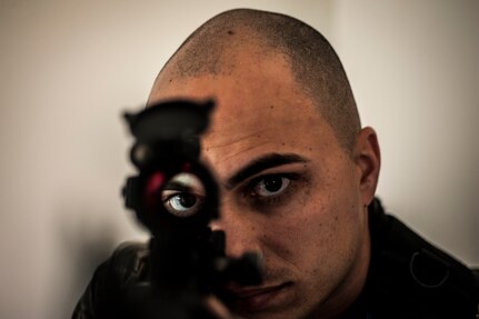 Staff Sgt. Vincent Bustillo, 628th Security Forces Squadron patrolman, looks through the scope mounted on his M4 carbine while performing close quarters battle training Jan. 28, 2013, at Joint Base Charleston – Air Base, S.C. (U.S. Air Force photo/Senior Airman Dennis Sloan)