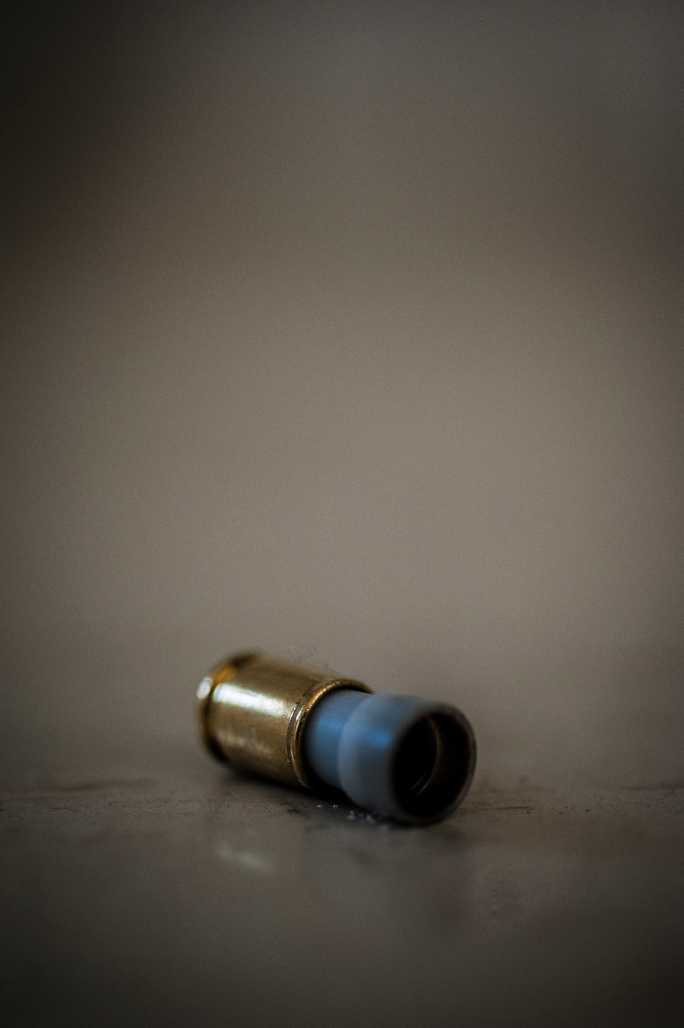 An M-9 pistol Simunition round casing lies on the ground after a 628th Security Forces Squadron Airman fired the round during a close quarters battle exercise Jan. 28, 2013, at Joint Base Charleston – Air Base, S.C. The unit requires all of its members to perform the CQB training twice a year. (U.S. Air Force photo/Senior Airman Dennis Sloan)