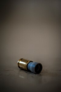 An M-9 pistol Simunition round casing lies on the ground after a 628th Security Forces Squadron Airman fired the round during a close quarters battle exercise Jan. 28, 2013, at Joint Base Charleston – Air Base, S.C. The unit requires all of its members to perform the CQB training twice a year. (U.S. Air Force photo/Senior Airman Dennis Sloan)