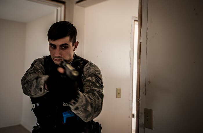 Staff Sgt. Brayden Dockendorf, 628th Security Forces Squadron patrolman, aims his M-9 pistol at a hallway while performing close quarters battle training Jan. 28, 2013, at Joint Base Charleston – Air Base, S.C. The unit requires all of its members to perform the CQB training twice a year. (U.S. Air Force photo/Senior Airman Dennis Sloan)