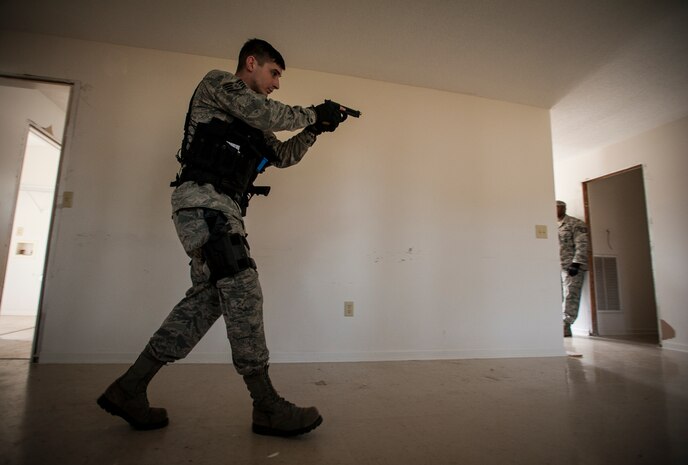 Staff Sgt. Brayden Dockendorf, 628th Security Forces Squadron patrolman, aims his M-9 pistol at a hallway while performing close quarters battle training Jan. 28, 2013, at Joint Base Charleston – Air Base, S.C. The unit requires all of its members to perform the CQB training twice a year. (U.S. Air Force photo/Senior Airman Dennis Sloan)