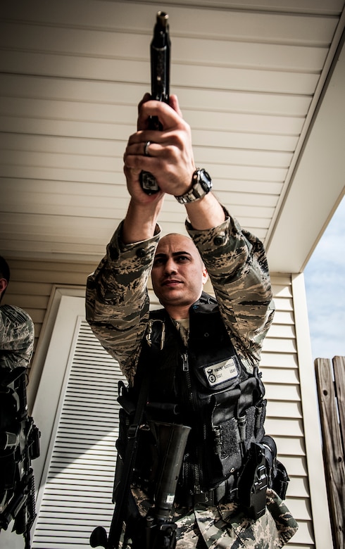 Staff Sgt. Vincent Bustillo, 628th Security Forces Squadron patrolman draws his M-9 pistol before performing close quarters battle training Jan. 28, 2013, at Joint Base Charleston – Air Base, S.C. The unit requires all of its members to perform the CQB training twice a year. (U.S. Air Force photo/Senior Airman Dennis Sloan)