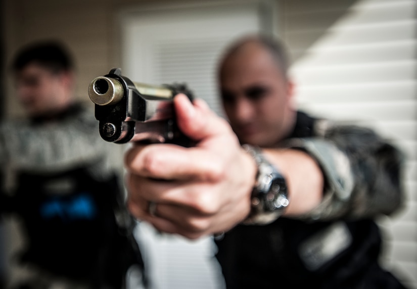 Staff Sgt. Vincent Bustillo, 628th Security Forces Squadron patrolman, and other security forces members, practice drawing their M9 pistols before performing close quarters battle training Jan. 28, 2013, at Joint Base Charleston – Air Base, S.C. The unit requires all of its members to perform the CQB training twice a year. (U.S. Air Force photo/Senior Airman Dennis Sloan)