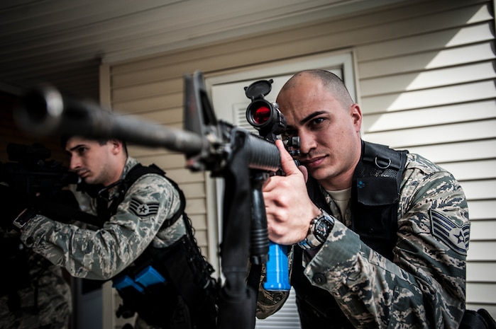 Staff Sgt. Vincent Bustillo, 628th Security Forces Squadron patrolman, looks through the scope mounted on his M4 carbine before performing close quarters battle training Jan. 28, 2013, at Joint Base Charleston – Air Base, S.C. The unit requires all of its members to perform the CQB training twice a year. (U.S. Air Force photo/Senior Airman Dennis Sloan)