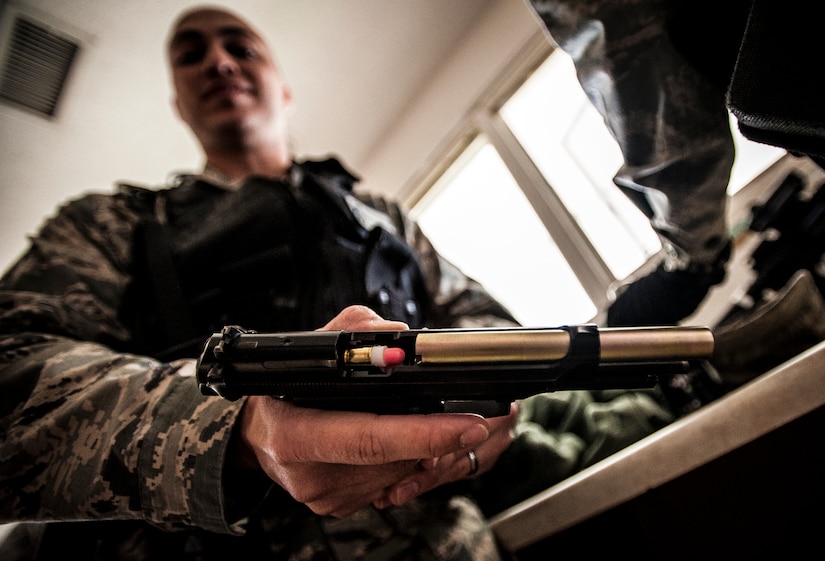 Staff Sgt. Vincent Bustillo, 628th Security Forces Squadron patrolman, loads Simunition rounds into his M-9 during a close quarters battle exercise Jan. 28, 2013, at Joint Base Charleston – Air Base, S.C. Simunition rounds are simulated rounds that leave a mark on the target. The unit requires all of its members to perform the CQB training twice a year. (U.S. Air Force photo/Senior Airman Dennis Sloan)