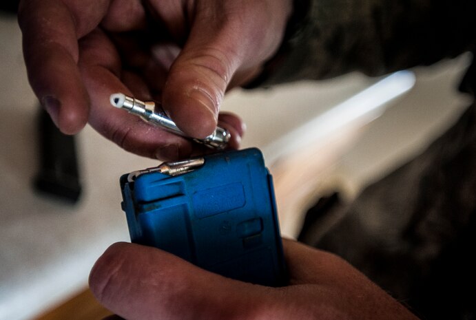 Staff Sgt. Vincent Bustillo, 628th Security Forces Squadron patrolman, loads Simunition rounds into an M4 carbine magazine during  a Close Quarters Battle exercise Jan. 28, 2013, at Joint Base Charleston – Air Base, S.C. Simunition rounds are simulated rounds that leave a mark on the target. The unit requires all of its members to perform the CQB training twice a year. (U.S. Air Force photo/Senior Airman Dennis Sloan)