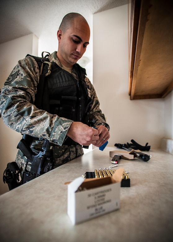 Staff Sgt. Vincent Bustillo, 628th Security Forces Squadron patrolman, loads simunition rounds into an M4 carbine magazine during a close quarters battle exercise Jan. 28, 2013, at Joint Base Charleston – Air Base, S.C. Simunition rounds are simulated rounds that leave a mark on the target. (U.S. Air Force photo/Senior Airman Dennis Sloan)