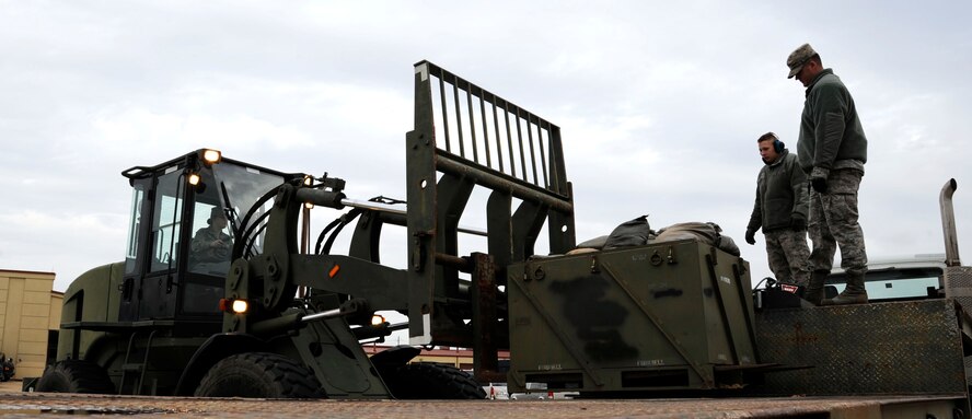 Staff Sgt. Shane Wilson and Airman 1st Class Jeremiah Leff, 2nd Logistics Readiness Squadron, observe Airman 1st Class Jaquelyn Mungavin, 2 LRS, place a box of sandbags during fork lift qualifications on Barksdale Air Force Base, La., Jan. 30. Wilson was training Leff and Mungavin in the use and operations of the 10k all-terrain fork lift. (U.S. Air Force photo/Airman 1st Class Andrew Moua)