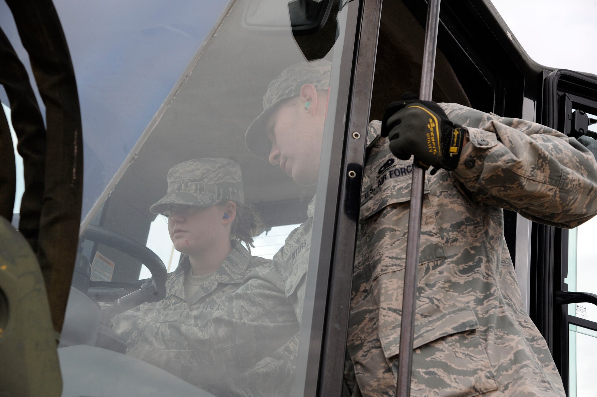 Staff Sgt. William Winters, 2nd Logistics Readiness Squadron, instructs Airman 1st Class Jaquelyn Mungavin, 2 LRS, on the controls of a 10k all-terrain fork lift on Barksdale Air Force Base, La., Jan. 30. The fork lift is capable of carrying 10,000 lbs., and can travel through rough terrain due to its large tires. This proves useful to Barksdale's mission by providing robust, reliable transportation of equipment to accomplish the mission. (U.S. Air Force photo/Airman 1st Class Andrew Moua)