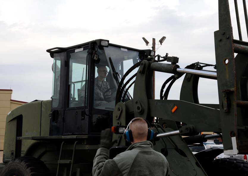 Airman 1st Class Karl Klein, 2nd Logistics Readiness Squadron vehicle operations, drives a 10k all terrain-fork lift as Airman Jeremiah Leff, 2 LRS vehicle operations, provides directions on Barksdale Air Force Base, La., Jan. 30. The vehicle operations section provides mission support by providing transportation for aircrew, distinguished visitors, and loading and moving cargo. (U.S. Air Force photo/Airman 1st Class Andrew Moua)