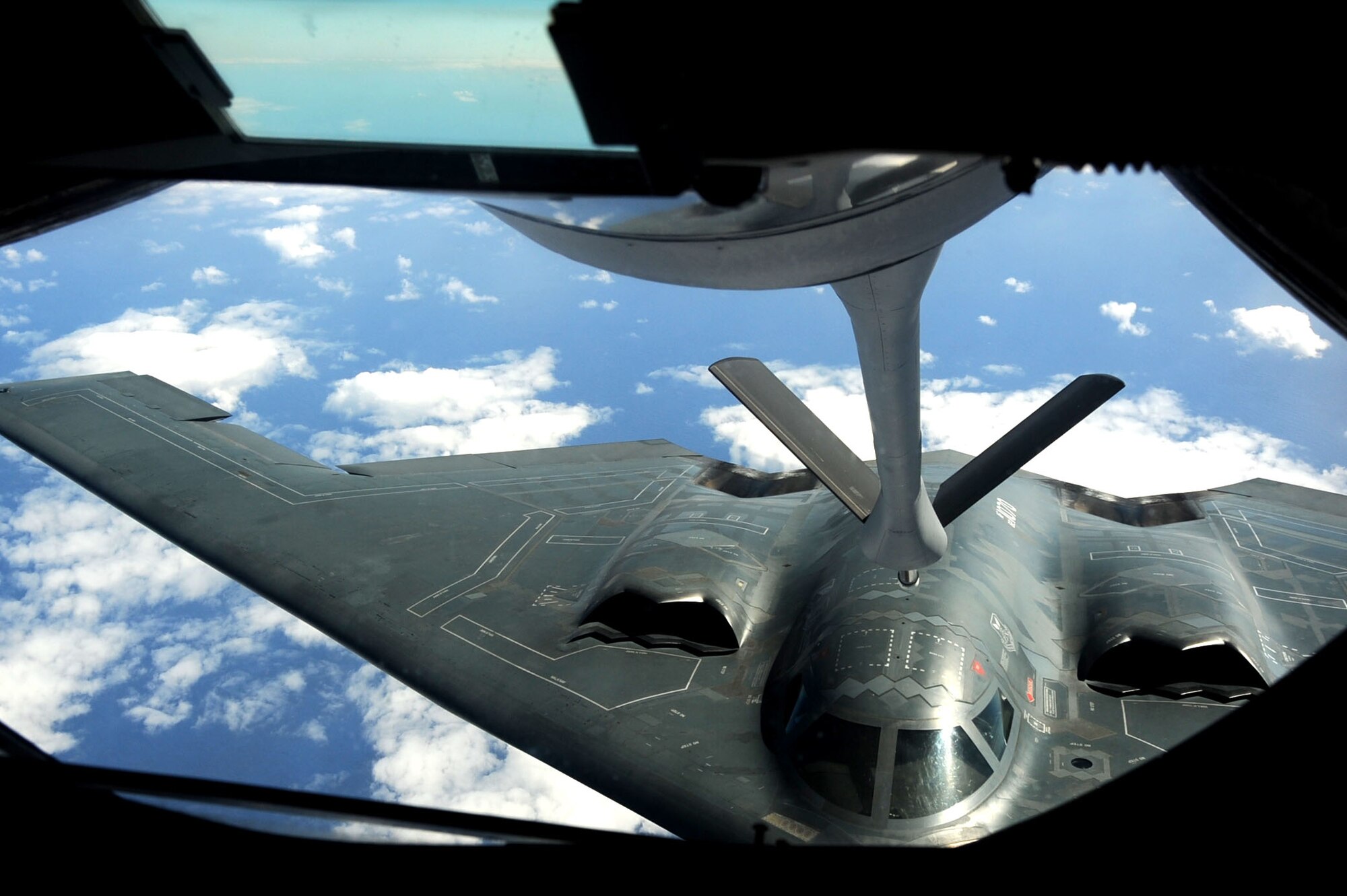 ANDERSEN AIR FORCE BASE, Guam -- A B-2 Spirit stealth bomber is refueled in-flight by a KC-135 on Jan. 23, 2013, over the Pacific Ocean. Two B-2 crews from the 509th Bomb Wing, Whiteman AFB, Mo., flew training missions out of Andersen AFB, Guam in support of in-theater training objectives.  (U.S. Air Force photo/Airman 1st Class Brooke P. Doyle)