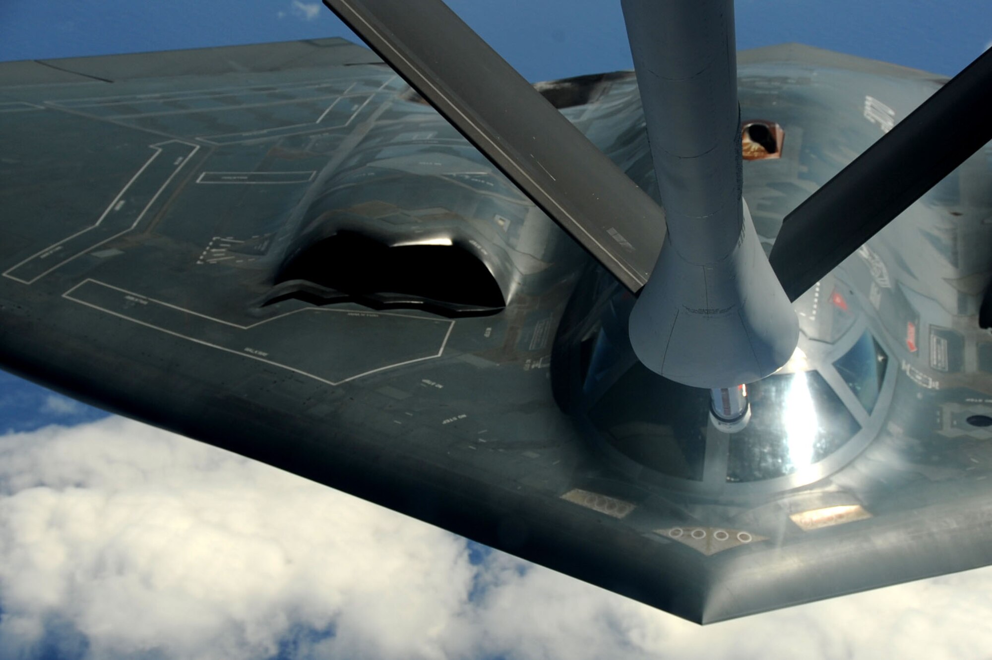 ANDERSEN AIR FORCE BASE, Guam -- A B-2 Spirit stealth bomber is refueled in-flight by a KC-135 on Jan. 23, 2013, over the Pacific Ocean. Two B-2 crews from the 509th Bomb Wing, Whiteman AFB, Mo., flew training missions out of Andersen AFB, Guam in support of in-theater training objectives.  (U.S. Air Force photo/Airman 1st Class Brooke P. Doyle)