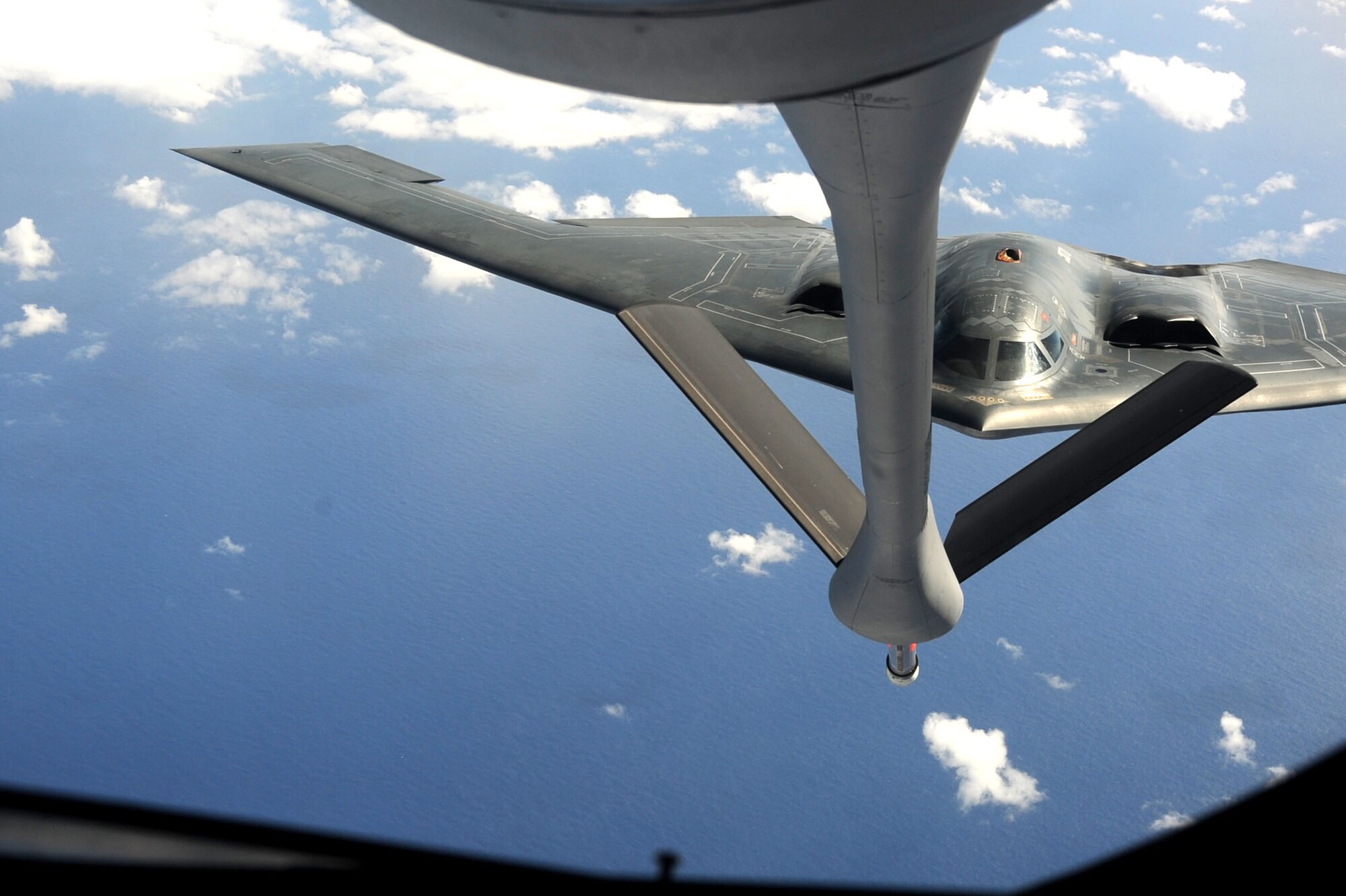 ANDERSEN AIR FORCE BASE, Guam -- A B-2 Spirit stealth bomber is refueled in-flight by a KC-135 on Jan. 23, 2013, over the Pacific Ocean. Two B-2 crews from the 509th Bomb Wing, Whiteman AFB, Mo., flew training missions out of Andersen AFB, Guam in support of in-theater training objectives.  (U.S. Air Force photo/Airman 1st Class Brooke P. Doyle)
