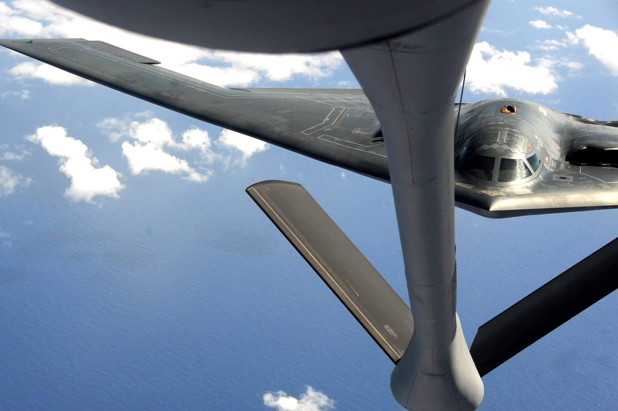 ANDERSEN AIR FORCE BASE, Guam -- A B-2 Spirit stealth bomber is refueled in-flight by a KC-135 on Jan. 23, 2013, over the Pacific Ocean. Two B-2 crews from the 509th Bomb Wing, Whiteman AFB, Mo., flew training missions out of Andersen AFB, Guam in support of in-theater training objectives.  (U.S. Air Force photo/Airman 1st Class Brooke P. Doyle)