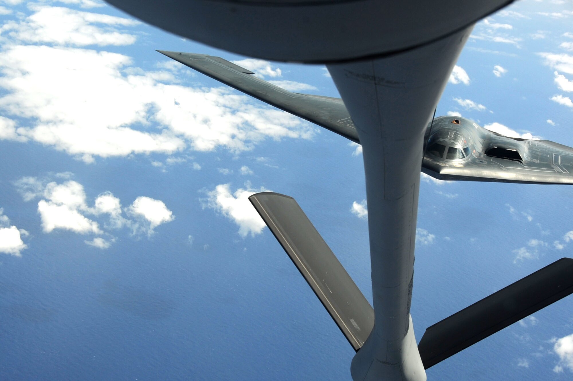 ANDERSEN AIR FORCE BASE, Guam -- A B-2 Spirit stealth bomber is refueled in-flight by a KC-135 on Jan. 23, 2013, over the Pacific Ocean. Two B-2 crews from the 509th Bomb Wing, Whiteman AFB, Mo., flew training missions out of Andersen AFB, Guam in support of in-theater training objectives.  (U.S. Air Force photo/Airman 1st Class Brooke P. Doyle)