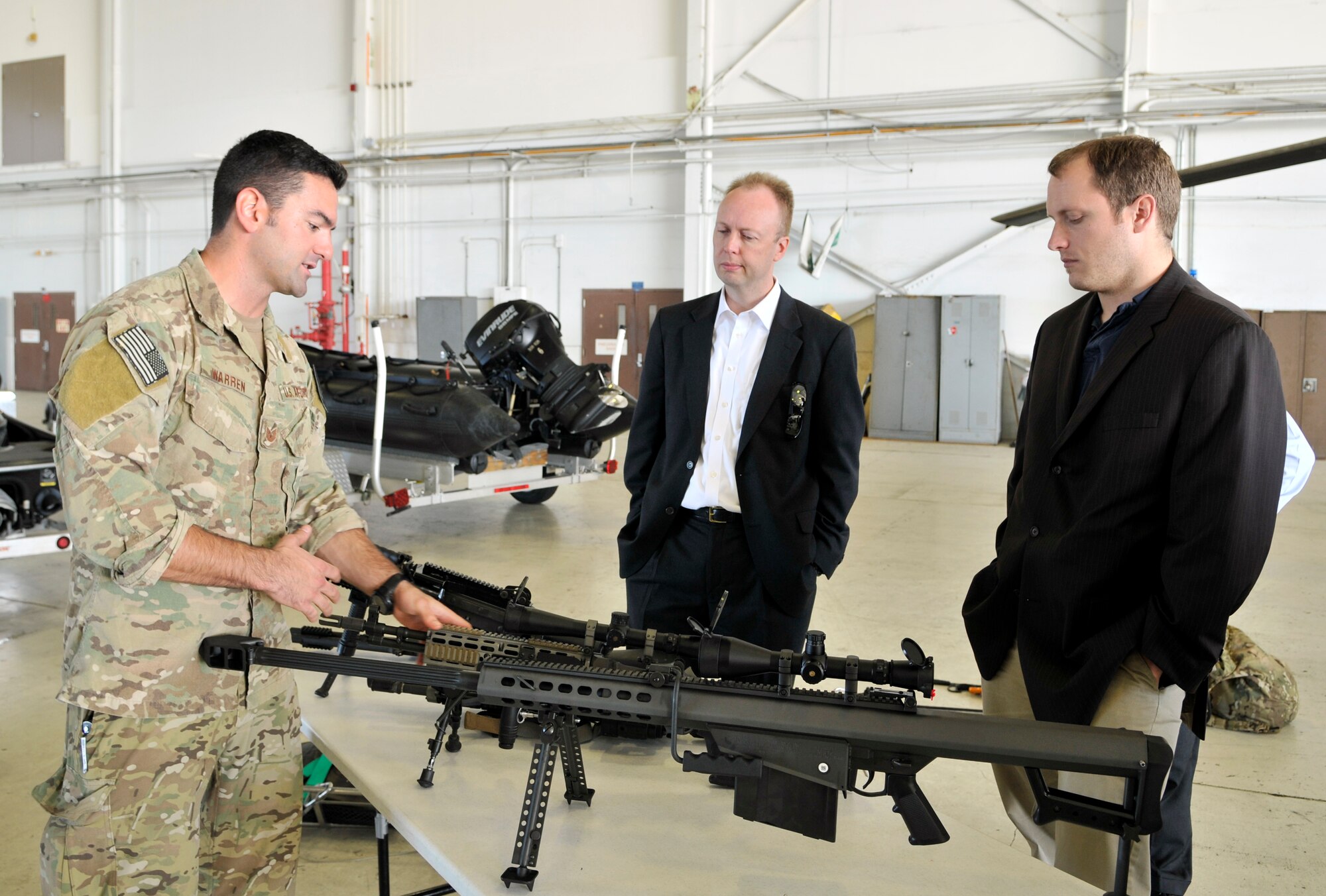 Tech. Sgt. Daniel Warren, 920th Rescue Wing, pararescueman shows congressional staffers the array of weapons utilized by guardian angels. The two were part of a congressional staffers group that traveled to Patrick Air Force Base, Fla., for a first-hand look at the 920th‘s rescue mission. The 920th RQW is a special operations wing and home to elite Guardian Angel Airmen who are among the most highly trained emergency trauma specialists in the U.S. military, and the only military personnel who are trained and equipped to conduct combat rescue for all of the other branches of the military. (U.S. Air Force photo/Tech. Sgt. Peter Dean)