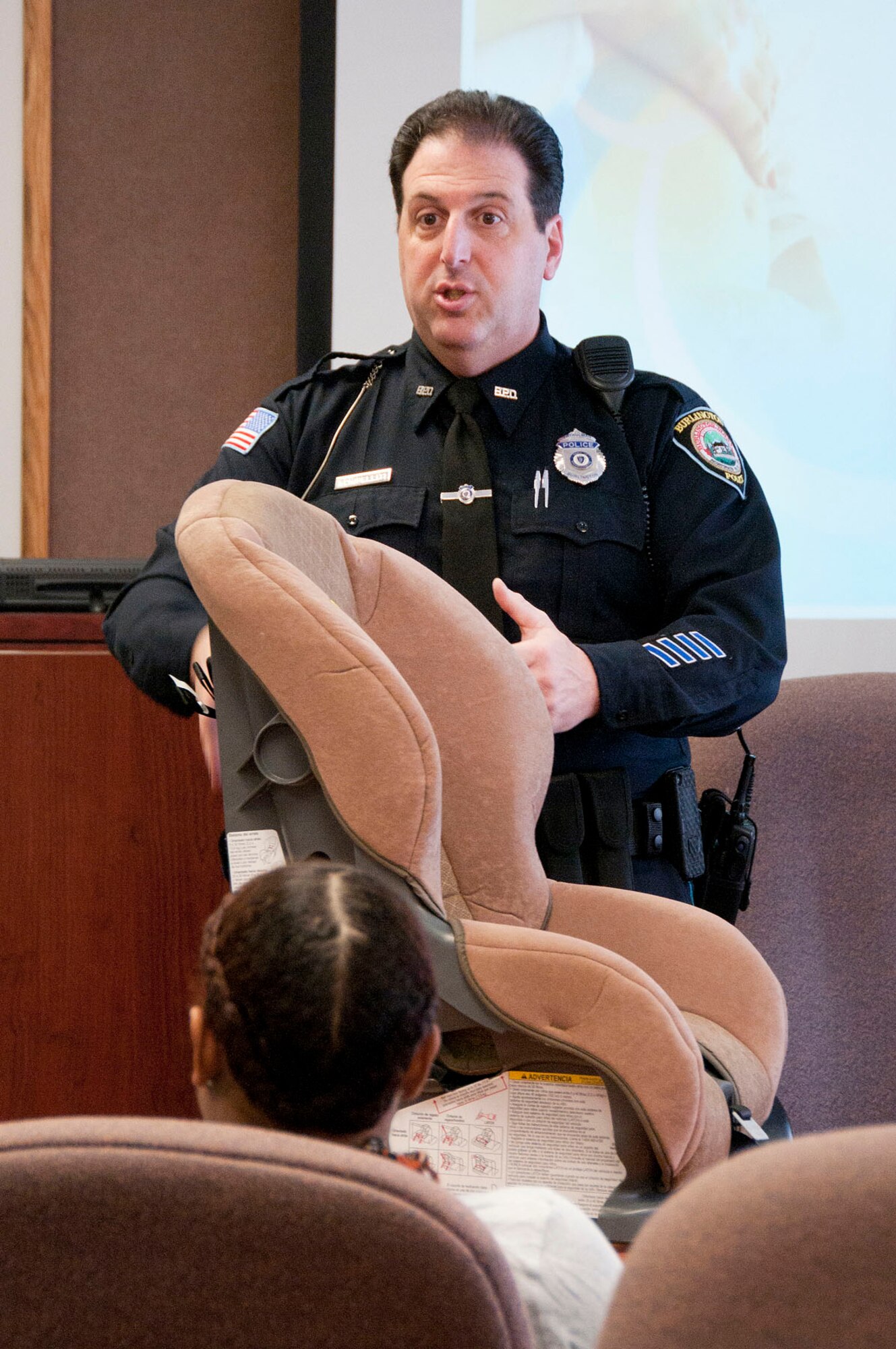 HANSCOM AIR FORCE BASE, Mass. - Officer Bernie Schipelliti of the Burlington Police Department teaches an infant car seat installation class at the Airman and Family Readiness Center Jan. 29 during the Bundles for Babies Class for expectant parents. Schipelliti, a trained instructor on infant car seat safety, has been volunteering for the class for more than eight years. (U.S. Air Force photo by Mark Wyatt)
