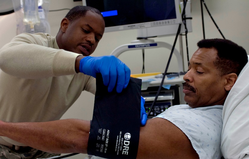 U.S. Air Force Staff Sgt. Perry Bailey, 633rd Medical Operations Squadron gastroenterology technician, places a blood pressure meter on the arm of Robert Taylor, a retired Airman and patient at U.S. Air Force Hospital Langley, Jan. 23, 2013, at Langley Air Force Base, Va. While eliminating the patients’ need to travel to health centers in the surrounding area for care, the clinic also stresses the importance of offering the same quality care as any similar service in the area.  (U.S. Air Force photo by Airman 1st Class R. Alex Durbin/Released)