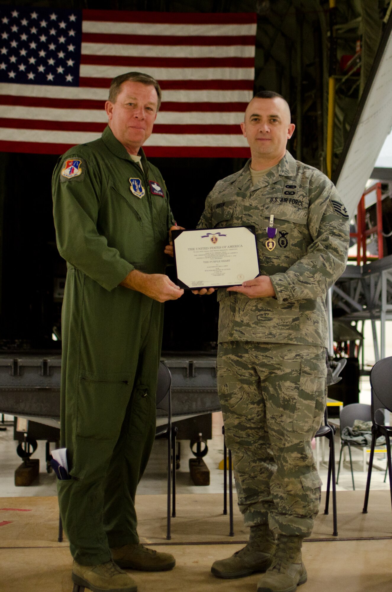 Staff Sgt. Troy Green (right), 139th Security Forces Squadron, poses for a photo with Brig. Gen. Stephen Cotter, assistant to the adjutant general – Air, Missouri National Guard, at Rosecrans Air National Guard Base, St. Joseph, Mo., Jan. 29, 2013. Green is the first member in the history of the 139th Airlift Wing to receive a Purple Heart, which he earned for sustaining combat injuries while deployed to Afghanistan. (U.S. Air Force photo/Master Sgt. Shannon Bond)
