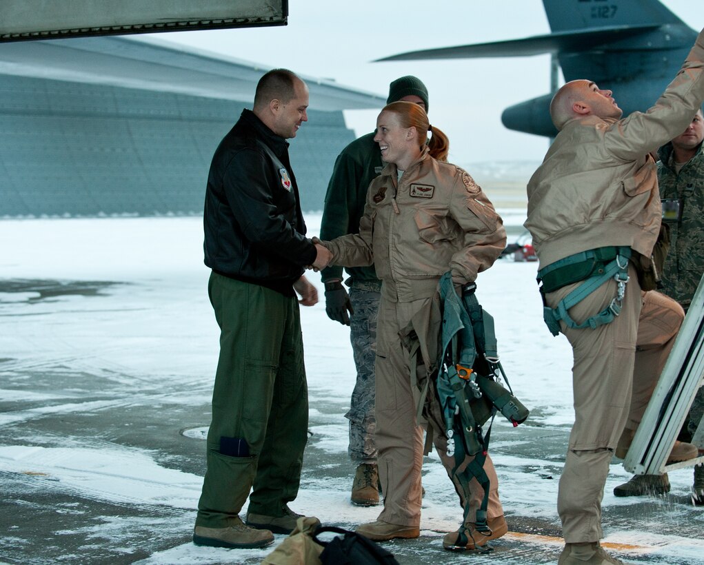 Col. John Nichols, 28th Operations Group commander, congratulates Capt. Kristen Jenkins, 37th Bomb Squadron instructor pilot, and the rest of the aircrew after returning from their six month deployment in Southwest Asia at Ellsworth Air Force Base, S.D., Jan. 23, 2013. Aircrews from Ellsworth provided critical air presence, precision strike, and surveillance and reconnaissance capabilities to support military objectives in the region. (U.S. Air Force photo by Airman 1st Class Alystria Maurer/Released)