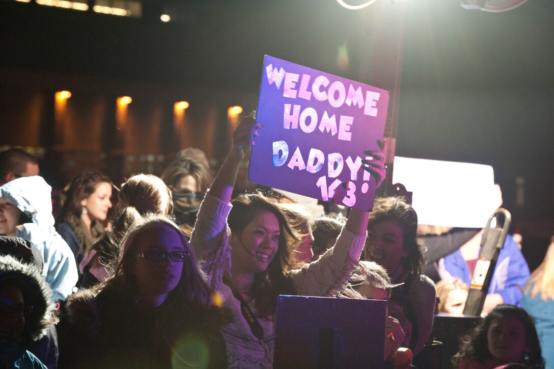 Friends, family and colleagues welcome loved ones home in the Pride Hangar at Ellsworth Air Force Base, S.D., Jan. 27, 2013. Approximately 200 Ellsworth Airmen returned home from a deployment to southwest Asia. (U.S. Air Force photo by Airman 1st Class Zachary Hada/Released)