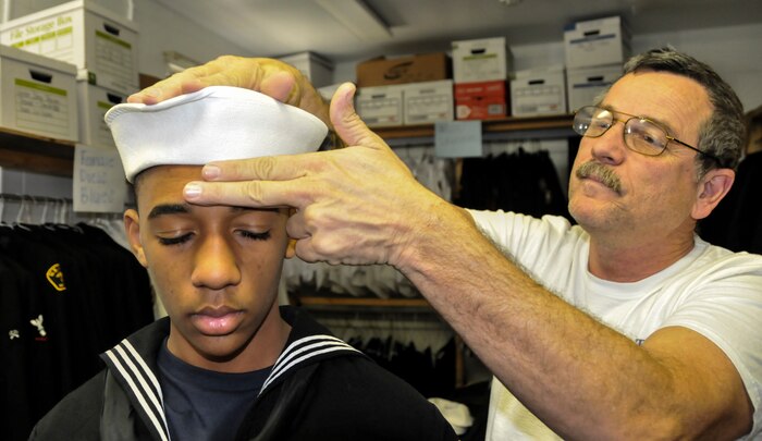 Lt. j.g. Dennis Doerr, Hunley-Yorktown Sea Cadet Division executive officer, teaches a new cadet how to properly wear his cap, Jan 26, 2013, at Joint Base Charleston – Weapons Station. More than 42 Sea Cadets from South Carolina and Georgia, ages 10 to 17, are a part of the Hunley-Yorktown Sea Cadet Division located in the Lowcountry. (U.S. Air Force photo/Airman 1st Class Jared Trimarchi) 
