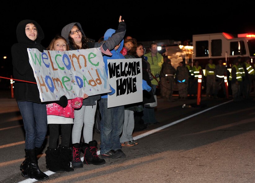 Friends and families await the arrival of their loved ones at the pride hangar at Ellsworth Air Force, S.D., Jan. 27, 2013. Approximately 200 Ellsworth Airmen returned from a six month deployment in support of operations in Southwest Asia. (U.S. Air Force photo by Airman 1st Class Anania Tekurio/Released)