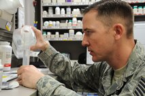 Tech. Sgt. Christopher Edgecomb, 21st Medical Squadron pharmacy technician and support flight chief, measures distilled water for medicine Jan. 28 at the base pharmacy. The pharmacy's mission is to provide medication services to active-duty members, which include getting them ready to deploy, keeping them healthy. Also, they provide services to dependents and retirees. (U.S. Air Force photo/Staff Sgt. Julius Delos Reyes)