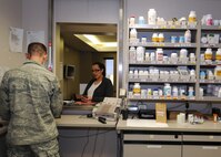 Tech. Sgt. Christopher Edgecomb, 21st Medical Squadron pharmacy technician and support flight chief, talks to Kathelin Avila about her prescription Jan. 28 at the base pharmacy. The pharmacy's mission is to provide medication services to active-duty members, which include getting them ready to deploy, keeping them healthy. Also, they provide services to dependents and retirees. (U.S. Air Force photo/Staff Sgt. Julius Delos Reyes)