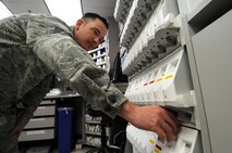 Tech. Sgt. Christopher Edgecomb, 21st Medical Squadron pharmacy technician and support flight chief, dispenses medication from a machine Jan. 28 at the base pharmacy. The pharmacy's mission is to provide medication services to active-duty members, which include getting them ready to deploy and keeping them healthy. Also, they provide services to dependents and retirees. (U.S. Air Force photo/Staff Sgt. Julius Delos Reyes)