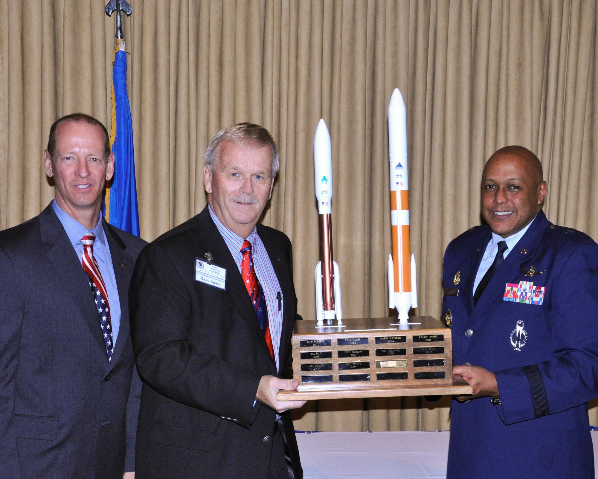 Keith Houston, CivMil chairman, and Brig. Gen. Anthony Cotton, 45th Space Wing commander, present Dave Spain with CivMil Person of the Year at the annual Civilian Military Community Relations Council Banquet, Saturday at the Tides. Mr. Spain has been a part of CivMil since 1979, and over the years, he has represented Brevard County at Air Force Space Command as part of the Space Command Civilian Advisory Board. (U.S. Air Force Photo/Staff Sgt. Erin Smith)