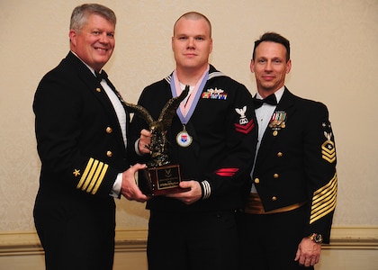 Navy Captain Thomas Bailey, Joint Base Charleston deputy commander, and Master Chief Petty Officer Billy Cady, JB Charleston – Weapons Station command master chief, present the Junior Sailor of the Year award to Petty Officer 2nd Class David Haeffner, Naval Support Activity culinary specialist, at the 628th Air Base Wing Annual Awards Banquet held at the Charleston Club, Jan. 25, 2013, at JB Charleston - Air Base, S.C. (U.S. Air Force photo/Staff Sgt. Rasheen Douglas)