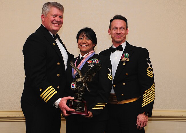 Navy Captain Thomas Bailey, Joint Base Charleston deputy commander, and Master Chief Petty Officer Billy Cady, JB Charleston – Weapons Station command master chief, present the Sailor of the Year award to Petty Officer 1st Class Jinnett Santos , Naval Support Activity culinary specialist, at the 628th Air Base Wing Annual Awards Banquet held at the Charleston Club, Jan. 25, 2013, at JB Charleston - Air Base, S.C. (U.S. Air Force photo/Staff Sgt. Rasheen Douglas)