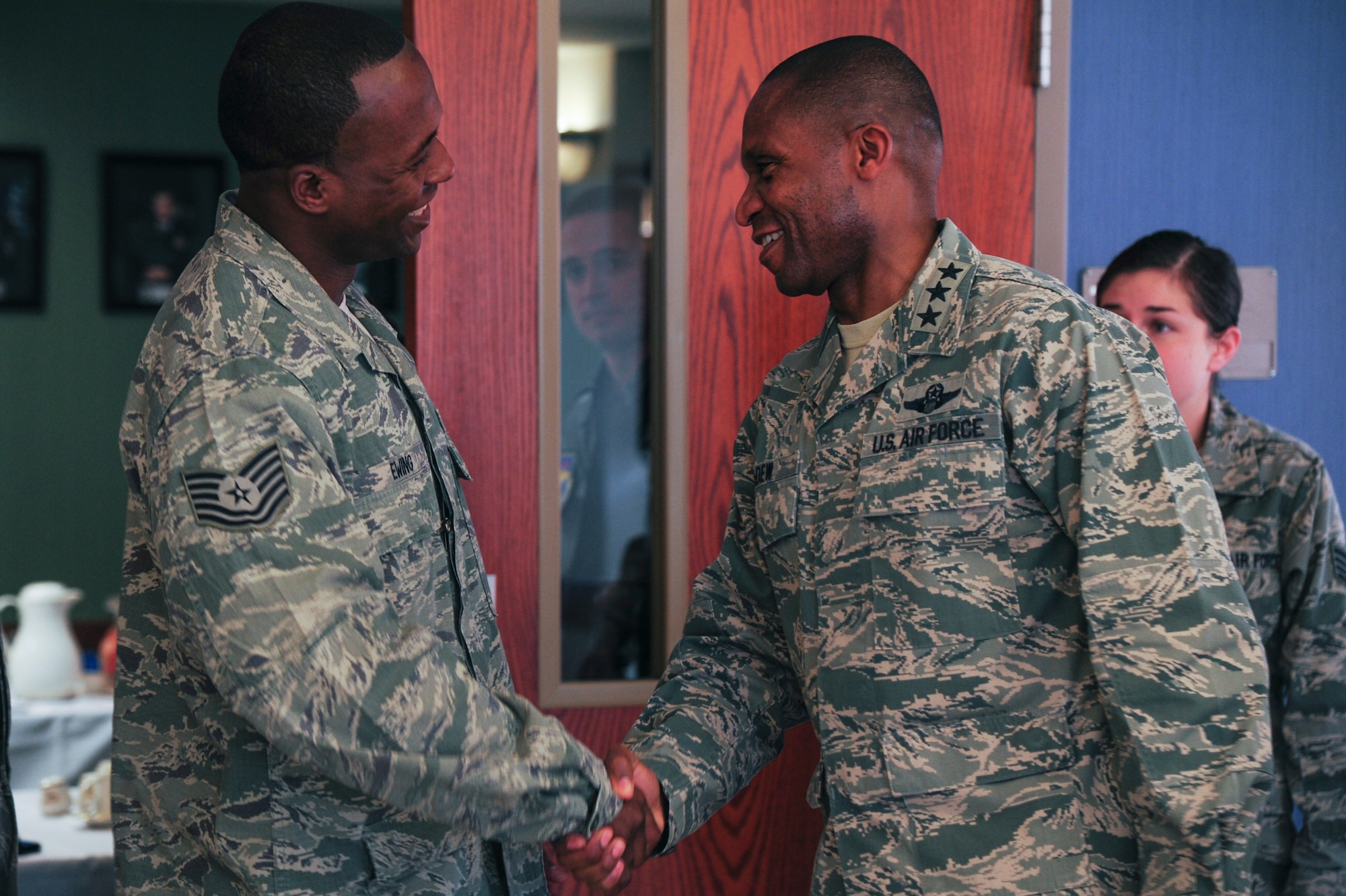 Tech. Sgt. Gregory Ewing, a 19th Civil Engineer Squadron electrical craftsman, greets Lt. Gen. Darren McDew, 18th Air Force commander, Jan. 25, 2013, Little Rock Air Force Base, Ark. during a question and answer session with non-commissioned officers and company grade officers. McDew visited with Team Little Rock members while touring base facilities and spoke at the Annual Awards Banquet.  (U.S. Air Force photo by Airman 1st Class Kaylee Clark)