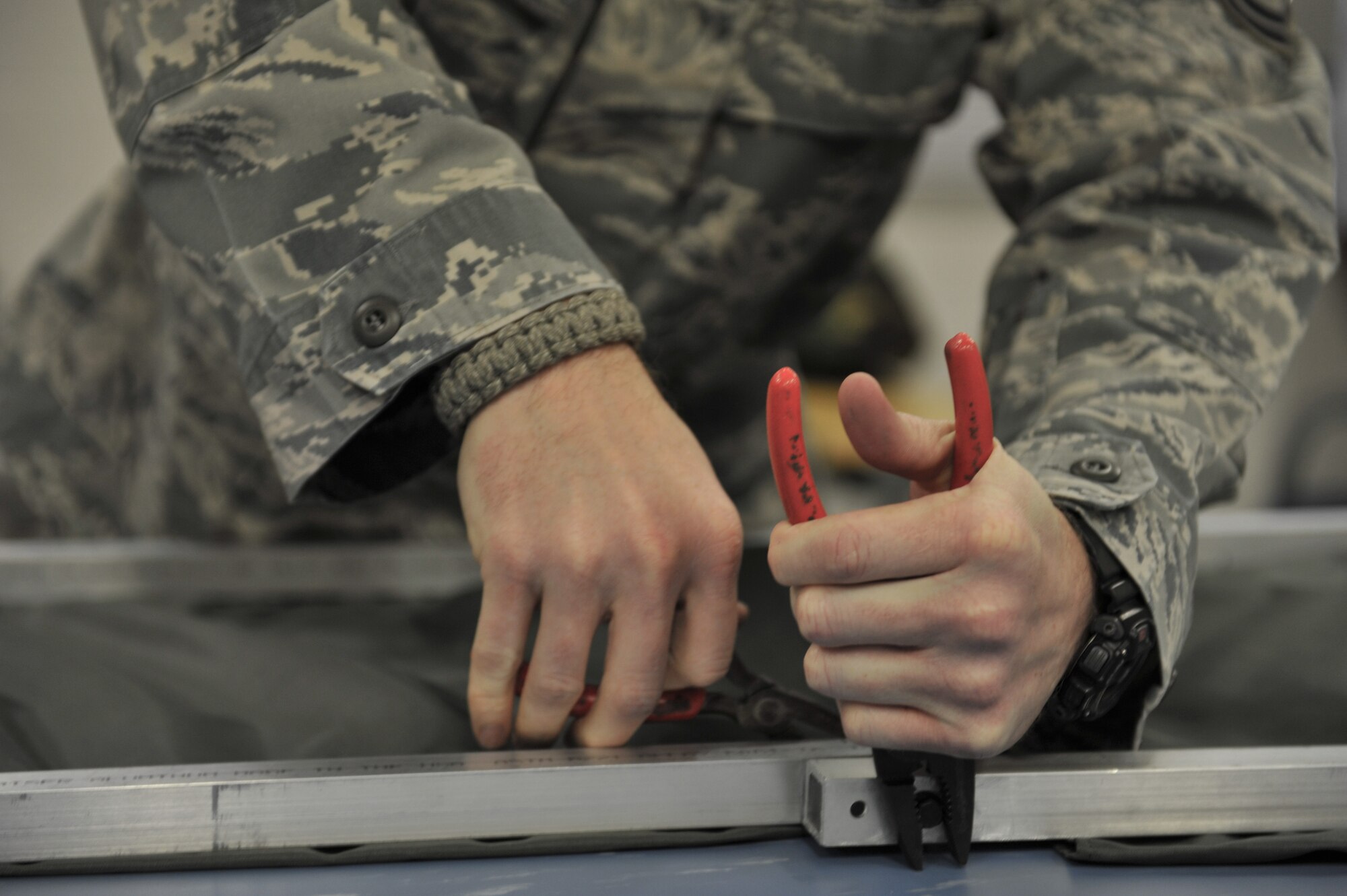 WHITEMAN AIR FORCE BASE, Mo. -- Master Sgt. Jacob Mann, 110th Bomb Squadron, Air National Guard, uses a pair of pliers to assemble an integrated prototype cot, Jan. 18. Mann is assigned to the 131st Operations Group and works closely with members of the 509th Operations Support Squadron to support Whiteman’s mission. (U.S. Air Force photo/Heidi Hunt) (Released)