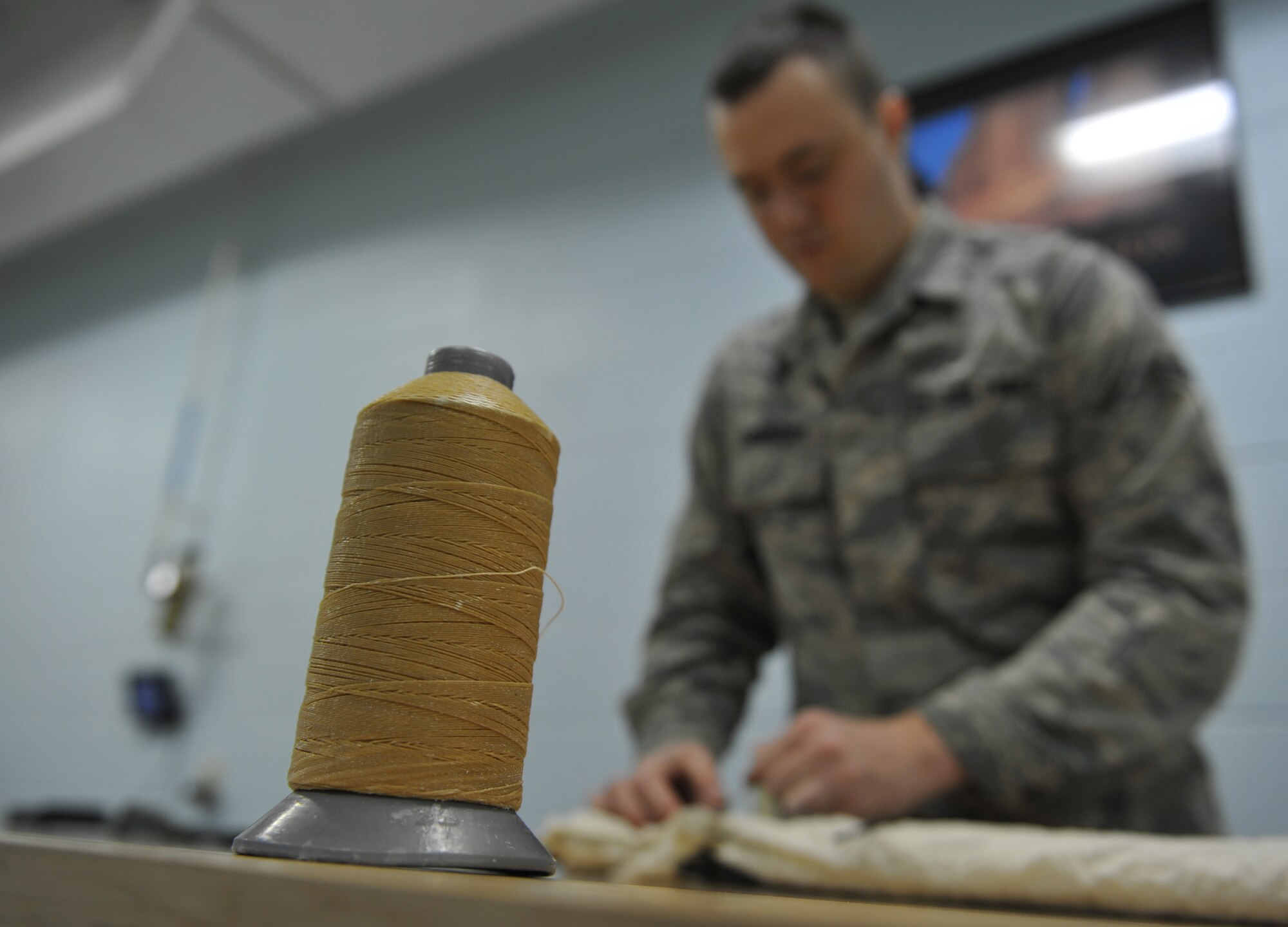 WHITEMAN AIR FORCE BASE, Mo. -- Airman 1st Class Chris Lineberry, 509th Operations Support Squadron aircrew flight equipment journeyman, checks the pull-test on the restrictor lanyard, Jan. 18. Airmen conduct pull-tests to ensure correct opening sequence on a parachute in case it were to deploy. (U.S. Air Force photo/Heidi Hunt) (Released)